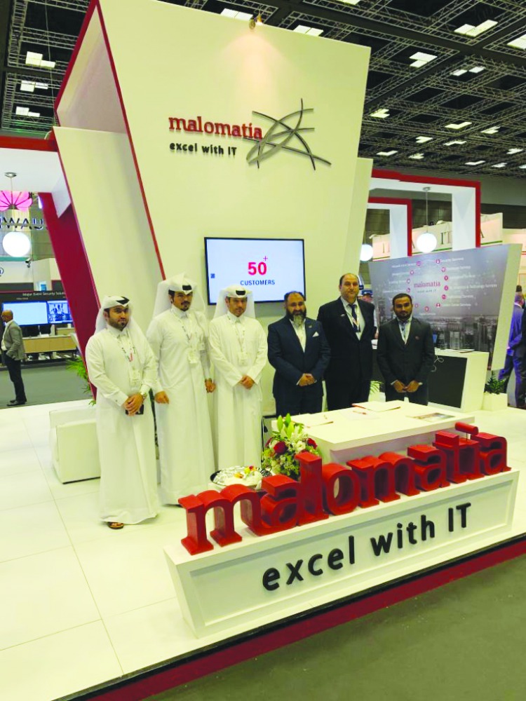 The officials posing for a group picture on the sidelines of QITCOM.