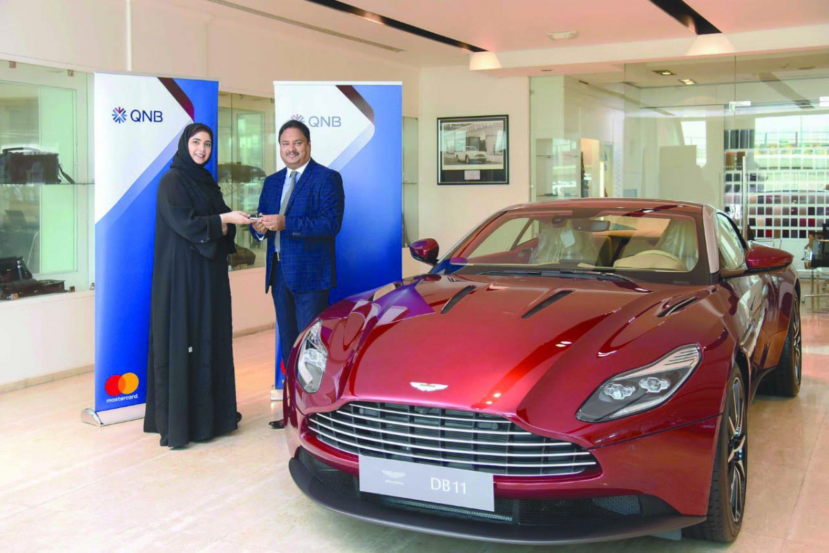 Heba Al Tamimi, General Manager, QNB Group Retail, giving away the grand prize to the winner Abraham Benjamin Pavutheril.