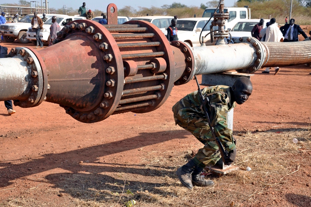 An armed member of the South Sudanese security forces is seen during a ceremony marking the restarting of crude oil pumping at the Unity oilfields in South Sudan, January 21, 2019. Reuters/Samir Bol