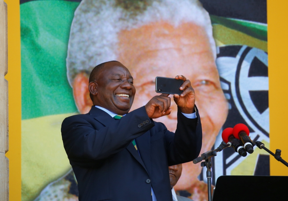 Cyril Ramaphosa use his phone during a rally to commemorate Nelson Mandela centenary year in Cape Town, February 11, 2018. Reuters / Mike Hutchings
