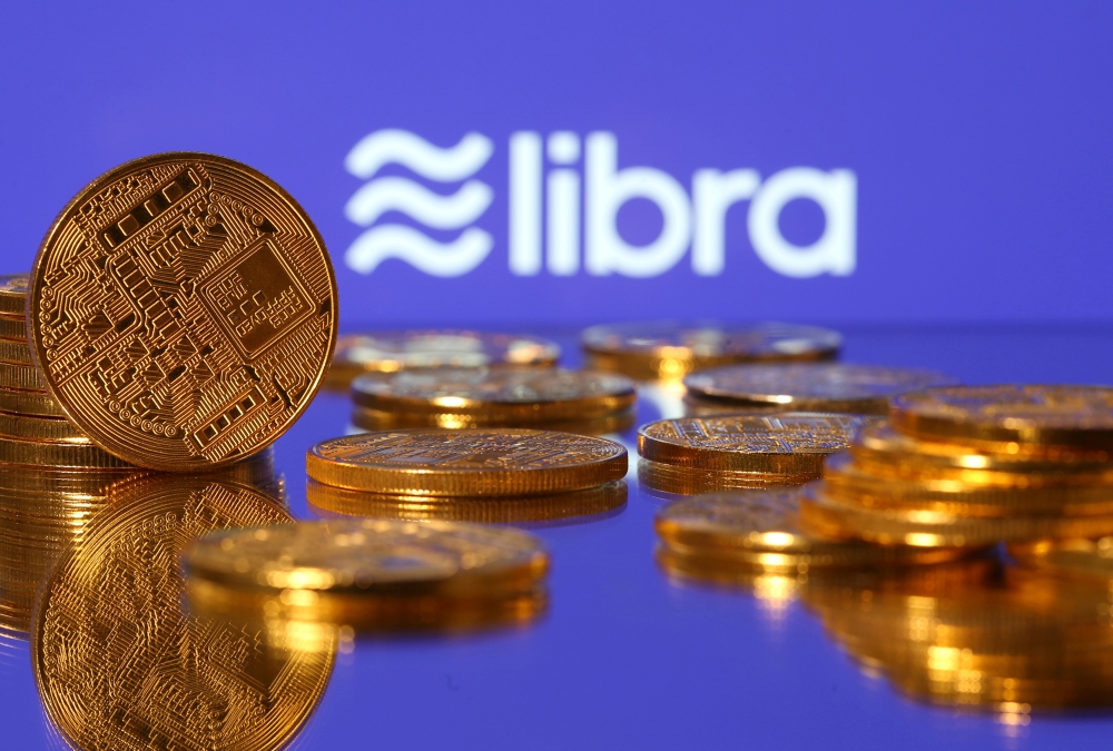 Representations of virtual currency are displayed in front of the Libra logo in this illustration picture, June 21, 2019. Reuters/Dado Ruvic