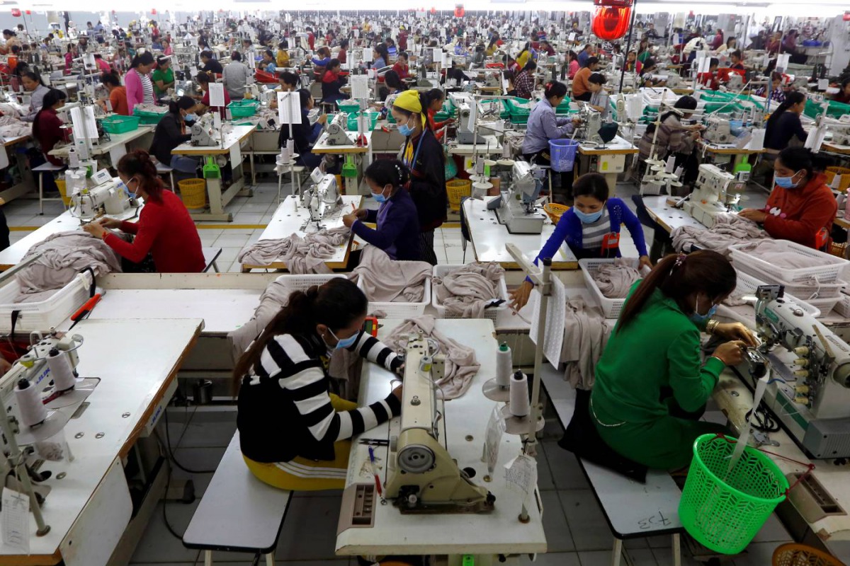 Employees work at a factory supplier of the H&M brand in Kandal province, Cambodia, December 12, 2018. Reuters/Samrang Pring