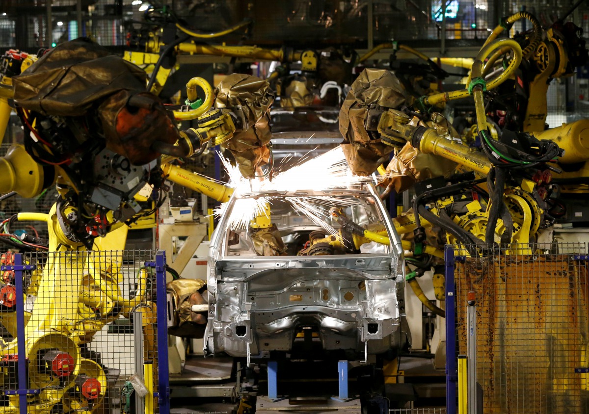Peugeot 208 automobiles are assembled at the PSA-Peugeot Citroen plant in Poissy near Paris, May 15, 2013. Reuters