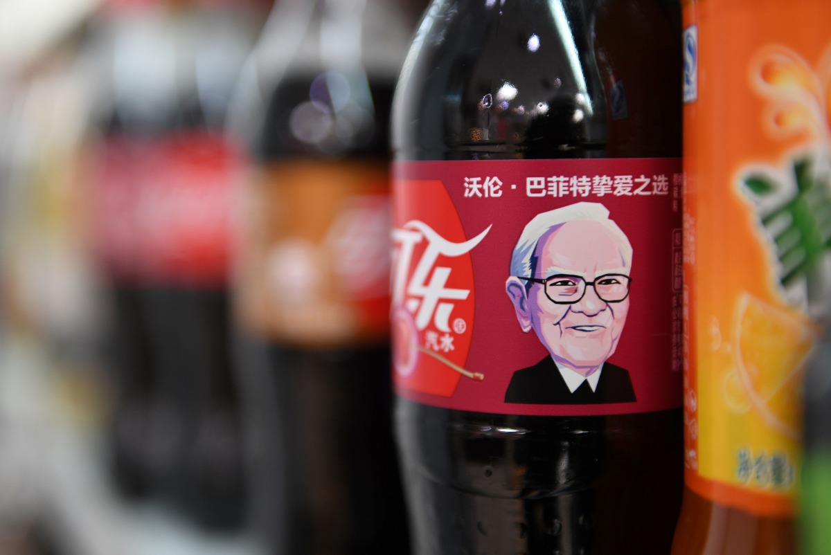A Cherry Coke bottle featuring an image of US investor Warren Buffet is seen on a shelf at a convenience store in Beijing on April 5, 2017 .AFP / Greg Baker