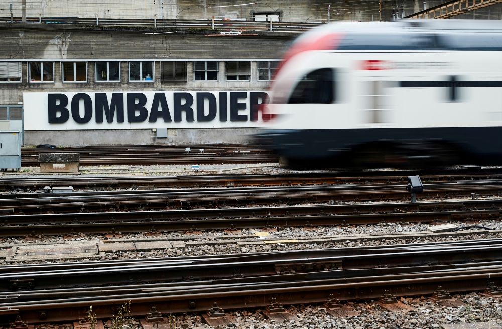 FILE PHOTO: A Bombardier advertising board is pictured in front of a Swiss train at the station in Bern, Switzerland, October 24, 2019. REUTERS/Denis Balibouse/File Photo