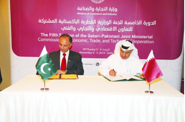 H E Ali bin Ahmed Al Kuwari (right), Minister of Commerce and Industry, and Omar Ayub Khan, Pakistan’s Federal Minister for Power, Petroleum and Natural Resources, signing a document on the sidelines  the fifth session of the Qatari-Pakistani Joint Minist