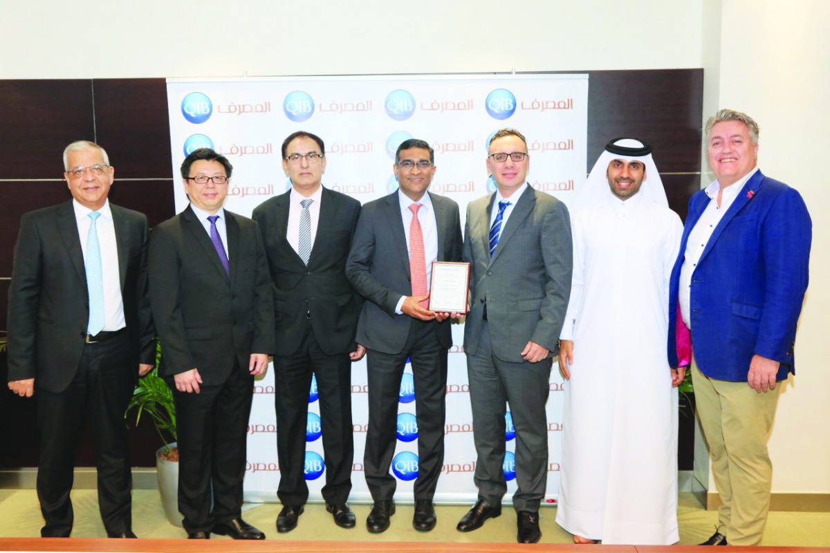 QIB officials posing for a group picture after receiving the award.