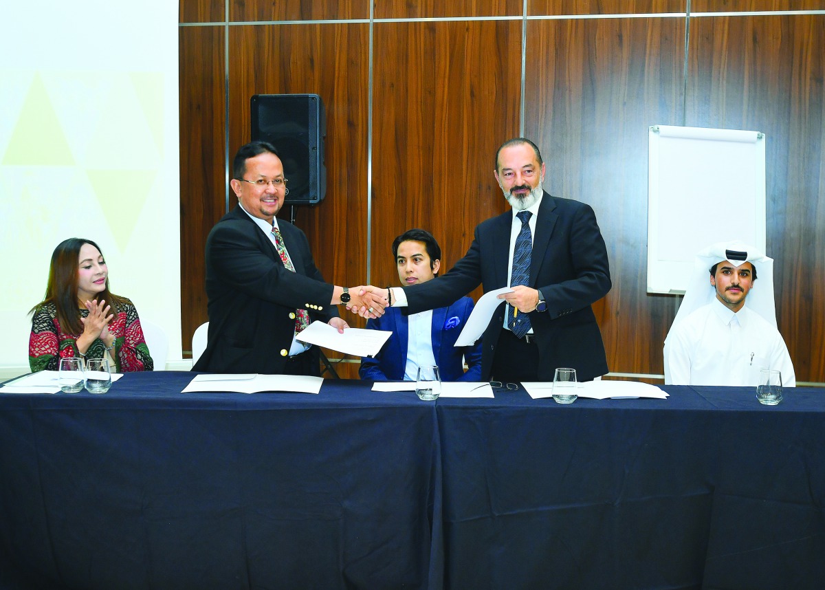 Shamsul Kahar Haron, CEO of International Islamic College, Malaysia (second left) shaking hands with Ammar Rayess (second right), Managing Partner, Atmosphere Projects, at the MoU signing ceremony in Doha, on Thursday. Present were Mohamad Shahir Sabarudi