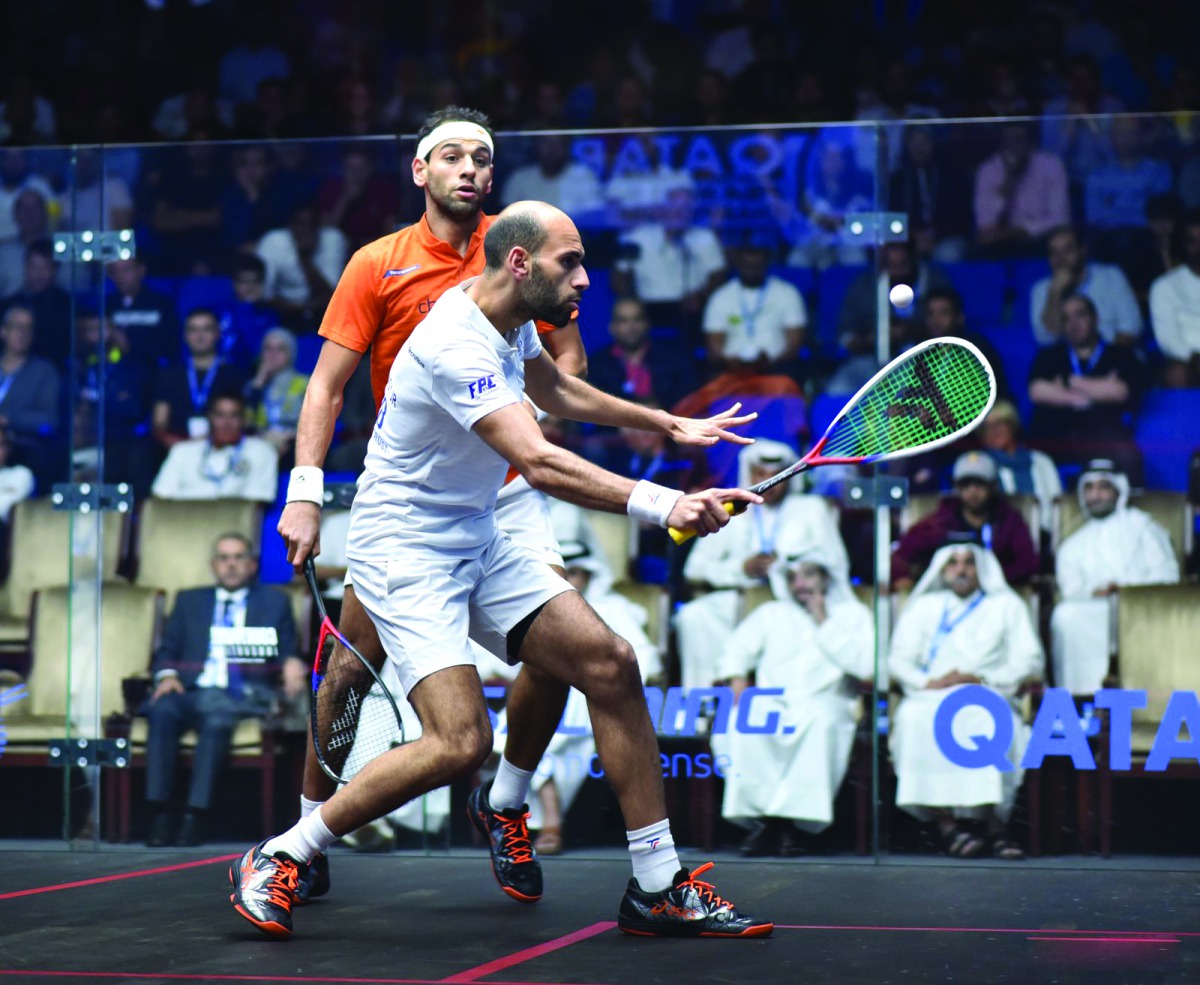 Egypt’s Marwan El Shorbagy (right) in action against Mohammed El Shorbagy in yesterday’s PSA World Championship quarter-final at the Khalifa International Tennis and Squash Complex in Doha.