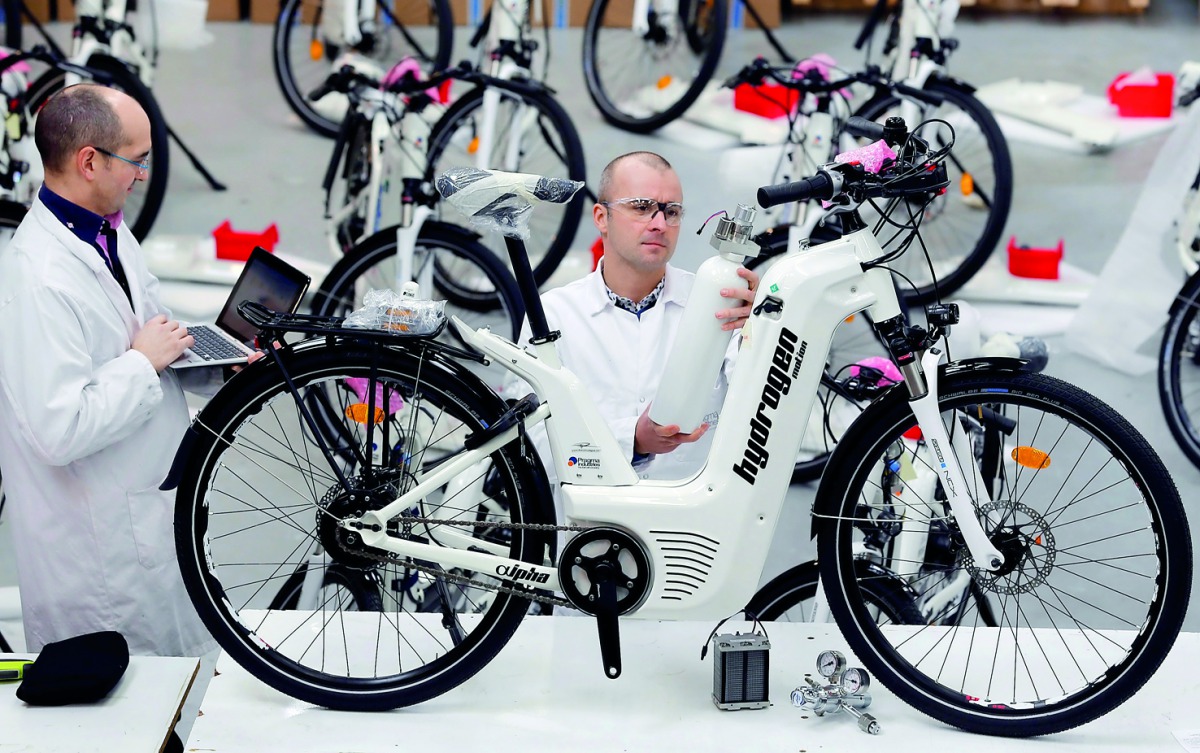 Pierre Forte (R)  founder CEO of Pragma Industries and Alexandre Blanc (L) operations director, check an Alpha bike at the Pragma Industries factory in Biarritz, France, January 15, 2018. Reuters / Regis Duvignau