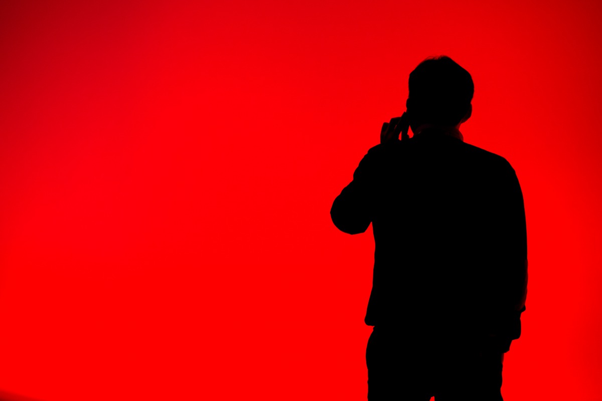 A visitor speaks on his mobile phone during the Mobile World Congress on the third day of the MWC in Barcelona on March 1, 2017. AFP / Josep Lago