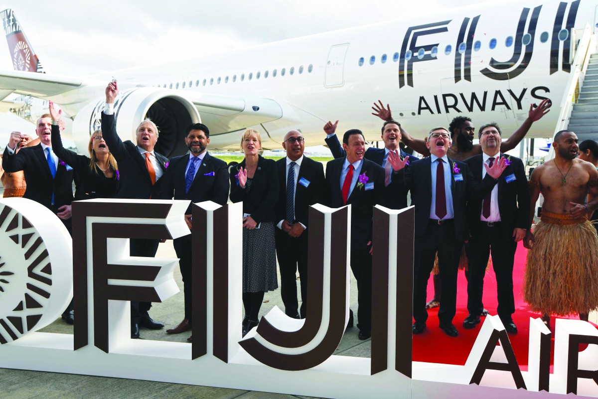 Fiji Airways CEO and managing director Andre Viljoen (C), DAE Capital president Dave Houlihan (C-R), Airbus Chief Commercial Officer Christian Scherer (3rd from R), Fiji Minister for Economy, Civil Service and Communication Aiyaz Sayed-Khaiyum (4th from L