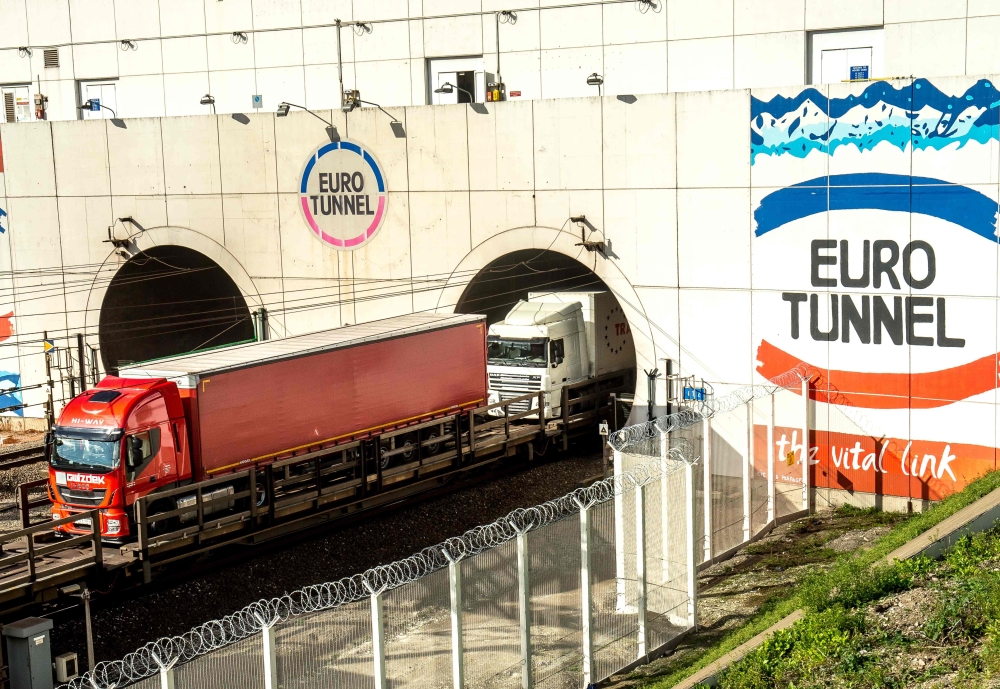 In this file photo taken on October 20, 2015 trucks arrive through a new Eurotunnel freight tunnel created to increase cross-English Channel trading in Coquelles. AFP / Philippe Huguen