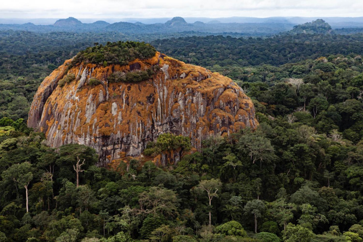 A large rock juts out from the tropical rainforest in the central African country of Gabon, August 23, 2012. (Josh Ponte Handout via Thomson Reuters Foundation) 