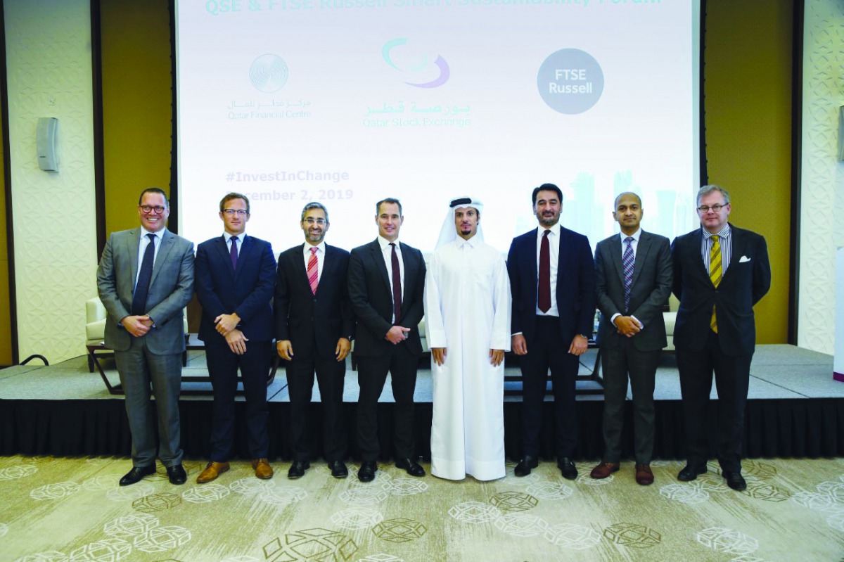 Hussein M Al Abdullah (fourth right), QSE Marketing and Communication Director with FTSE Russell CEO Waqas Samad (third right) and senior market experts and officials on the sidelines of  the seminar  in Doha, Monday.