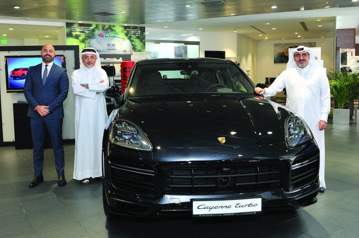The officials of Porsche Centre Doha, Salman Jassem Al Darwish (right), Chairman and CEO; and Ahed Dawood (second left), Brand Manager, during the launch of Cayenne Coupé at the Porsche Centre Doha, The Pearl-Qatar, in Doha yesterday. Pic: Salim Matramkot