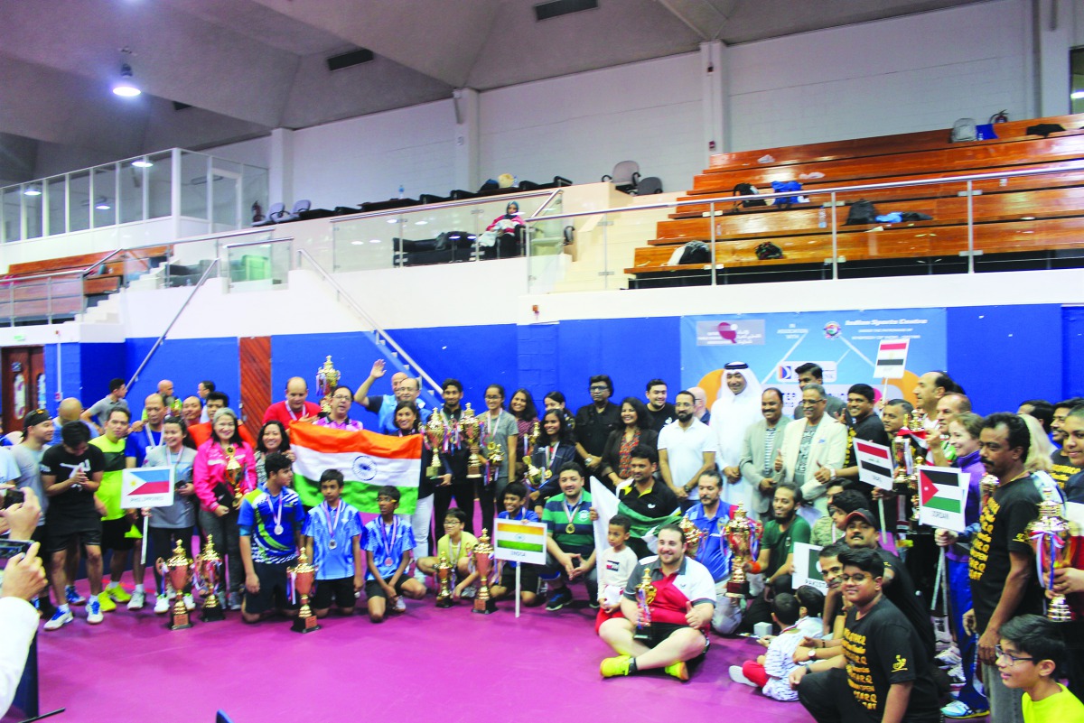 Players and officials pose for a group photo after the conclusion of Qatar Oruma Open Badminton Championship 2019.