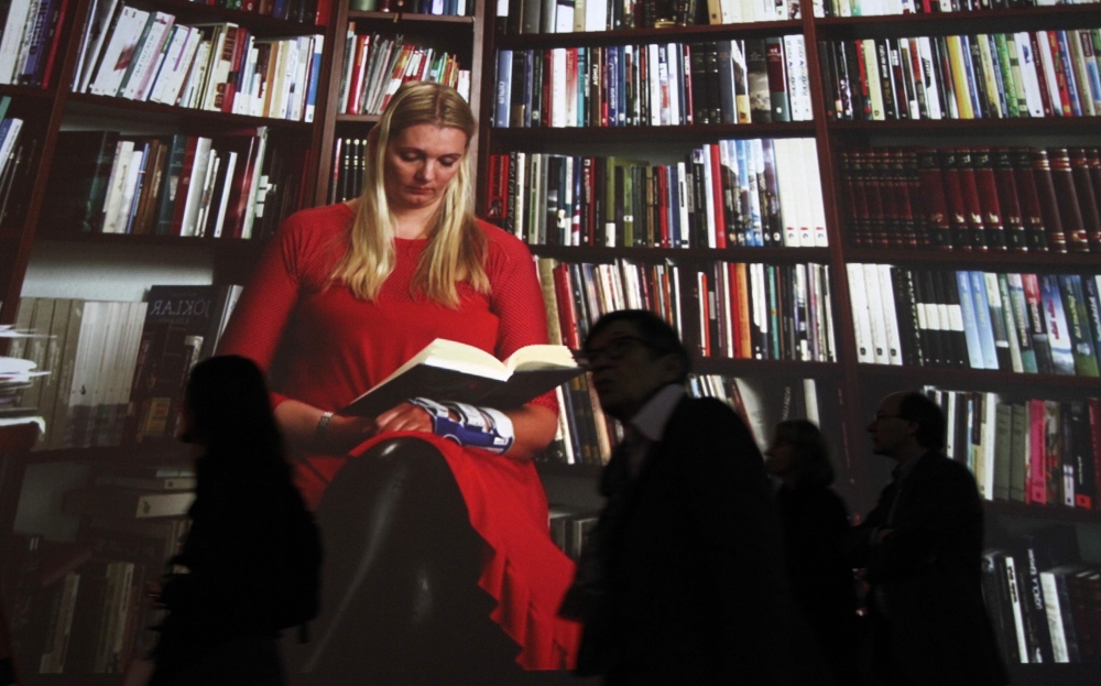 Visitors check out the Iceland pavilion featuring giant projections of people reading, on October 12, 2011 at the Frankfurt Book Fair, where Iceland was the guest of honour in 2011. AFP / Daniel Roland