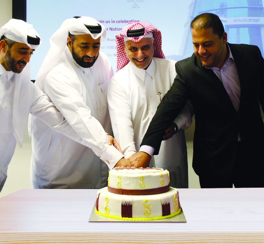 Officials cutting a cake.