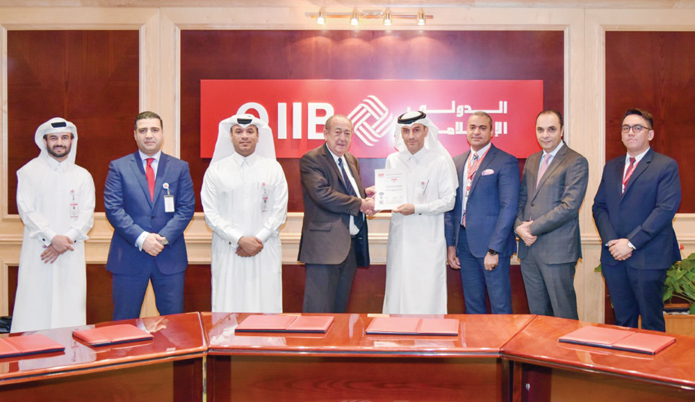 QIIB Deputy CEO Jamal Abdullah Al Jamal  receiving the honour at the event held at QIIB headquarters.