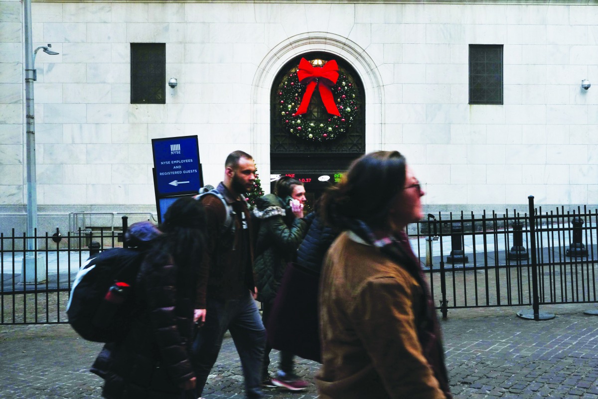 People walk by the New York Stock Exchange (NYSE) during the beginning of the Christmas holiday week on December 23, 2019 in New York City.  Spencer Platt/Getty Images/AFP