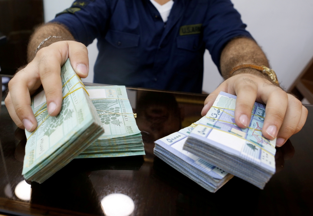 FILE PHOTO: A money exchange vendor displays Lebanese pound banknotes at his shop in Beirut, Lebanon, August 16, 2018. REUTERS/Mohamed Azakir