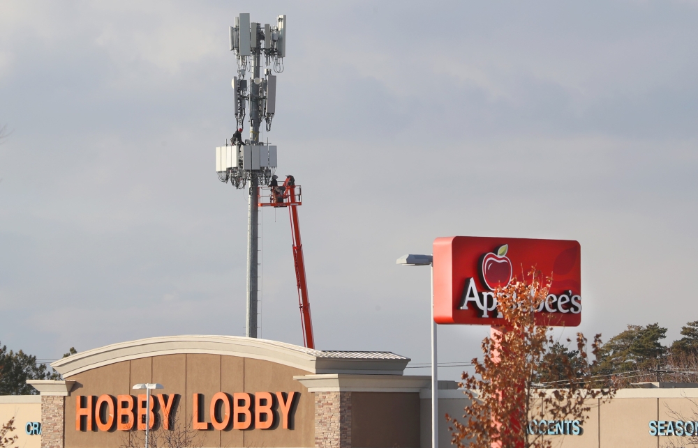 Several stores sits in front of a cell tower as workers rebuild a cellular tower with 5G equipment for the Verizon network on November 26, 2019 in Orem, Utah. George Frey / Getty Images / AFP