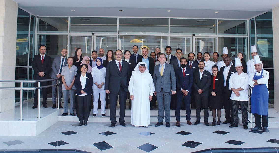 Sheikh Faisal bin Qassim Al Thani (centre), Chairman, ARTIC and DoubleTree by Hilton Doha - Al Sadd  team posing for a group picture during the opening ceremony.