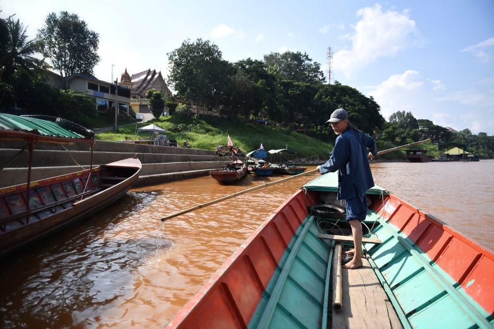 Niwat Roikaew, conservationist and head of the Rak Chiang Khong group, on a boat in the Chiang Khong district in the northern Thai province of Chiang Rai on September 20, 2019.  AFP / Lillian Suwanrumpha