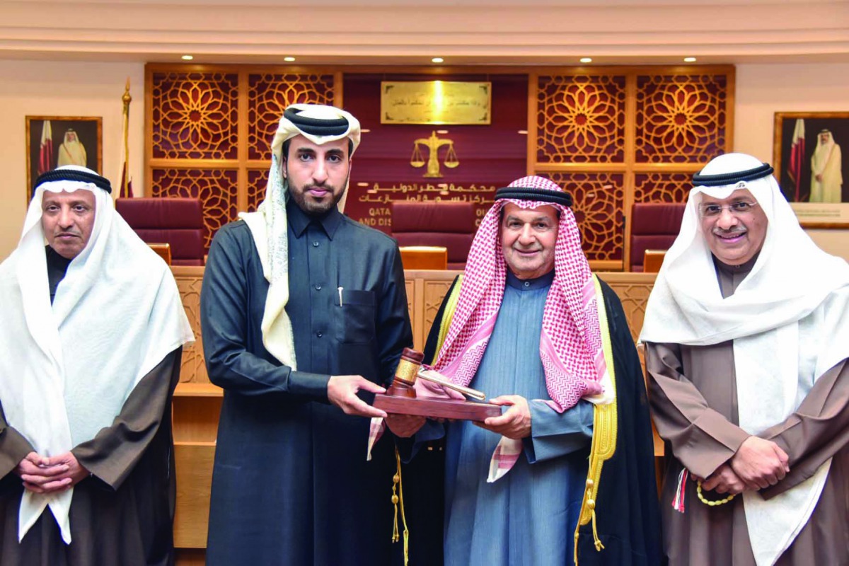Qatar International Court CEO Faisal Al Sahouti (second left), presenting a memento to the head of  Kuwait delegation.