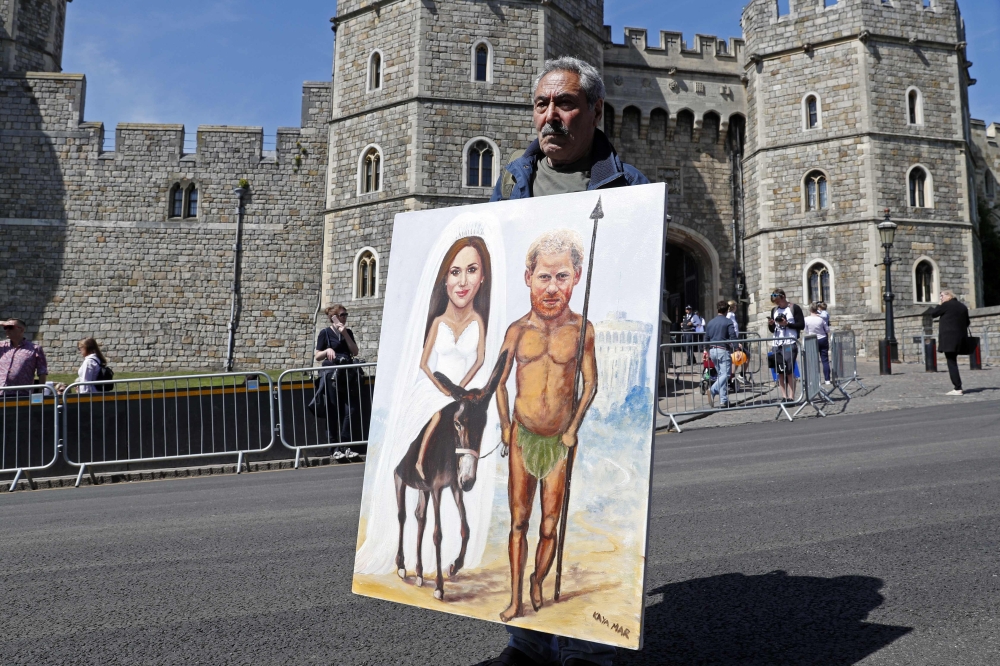 File photo: Artist Kaya Mar shows off his latest work in front of the castle in Windsor on May 17,  2018 two days before the royal wedding of Prince Harry and Meghan Markle. AFP / Adrian Dennis
