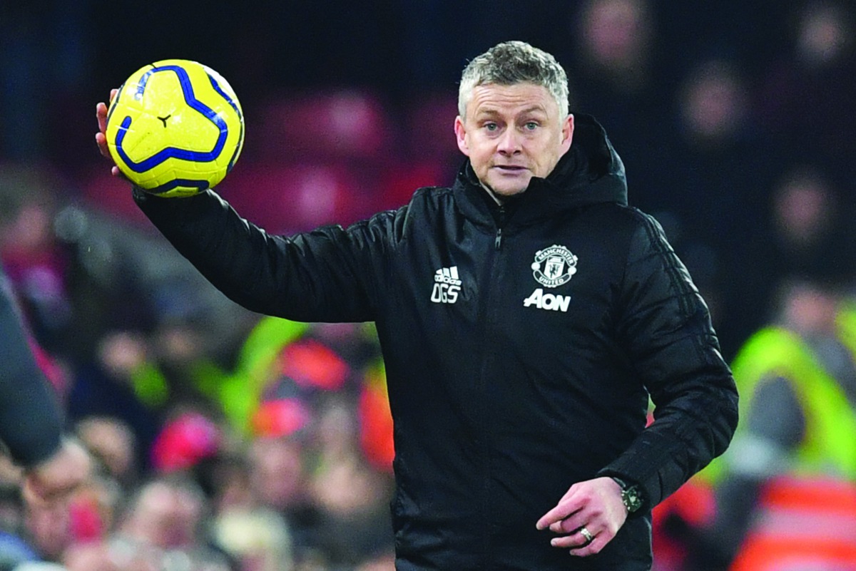 Manchester United's Norwegian manager Ole Gunnar Solskjaer throws the ball back in from the touchline during the English Premier League football match between Liverpool and Manchester United at Anfield stadium in Liverpool, north west England on January 1
