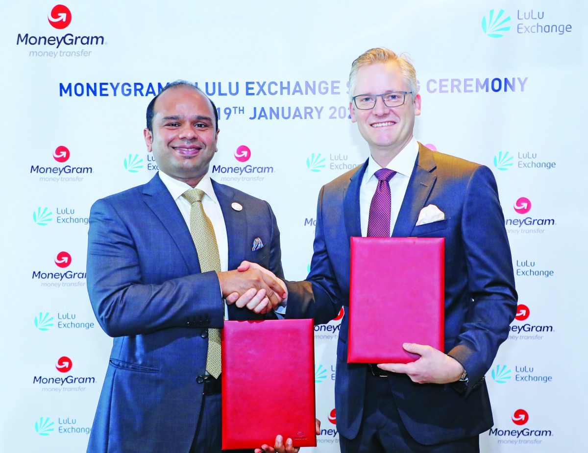 Adeeb Ahmed (left) and Alex Holmes during the signing ceremony.