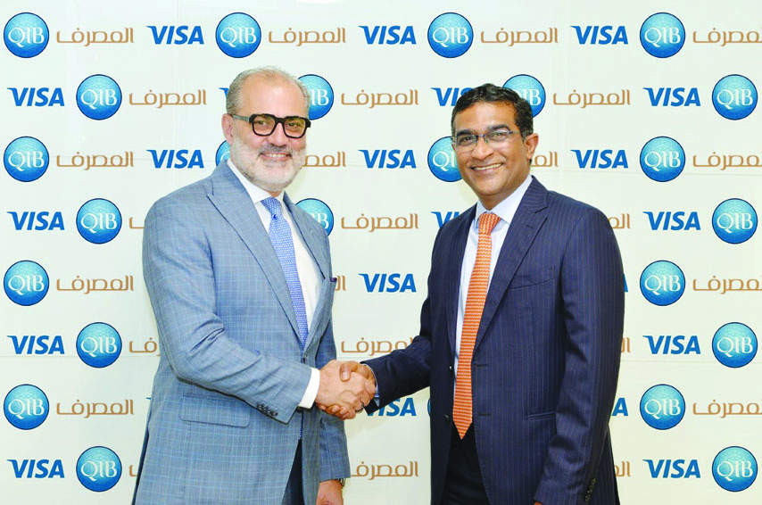 QIB’s Personal Banking Group General Manager, D. Anand (right) and  Marcello Baricordi, Visa’s General Manager for Middle East and North Africa, shaking hands after announcing the partnership.