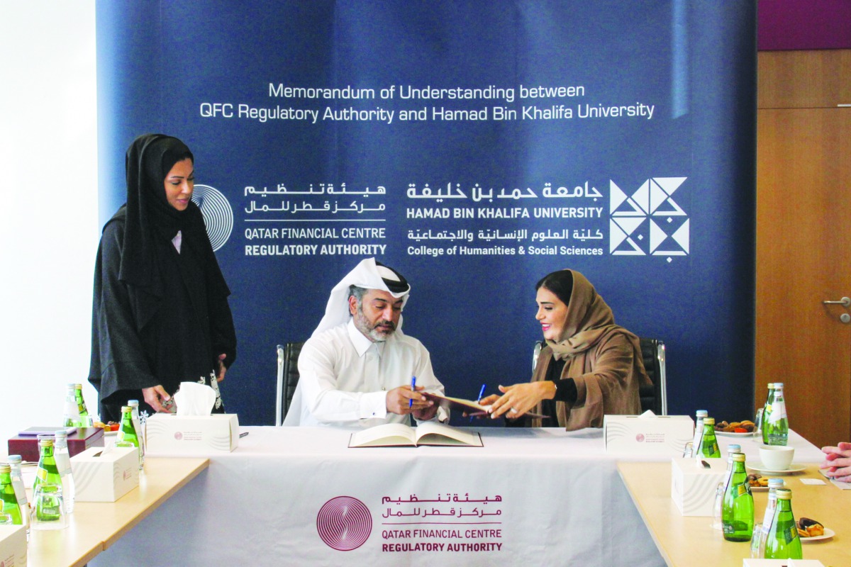 Eisa Ahmed Abdulla (sitting, left), Chief Operating Officer and Managing Director, Corporate Services of the Regulatory Authority and Dr Amal Mohammed Al Malki, Founding Dean, College of Humanities and Social Sciences, Hamad Bin Khalifa University, exchan
