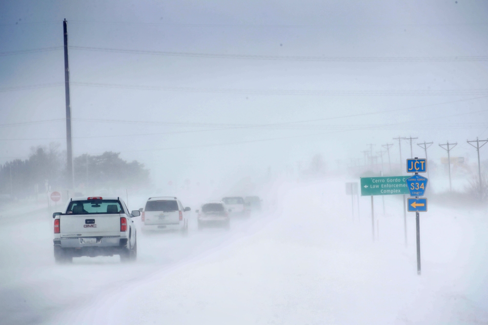 Motorists navigate an ice and snow-covered road on November 27, 2019 in Mason City, Iowa. Scott Olson / Getty Images / AFP