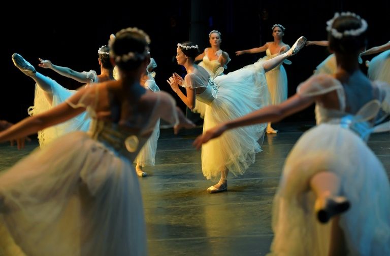 Ballet dancers perform during a rehearsal before the opening night of a ballet production at the Municipal Theater in Rio de Janeiro, Brazil, June 20, 2018. AFP / Carl De Souza