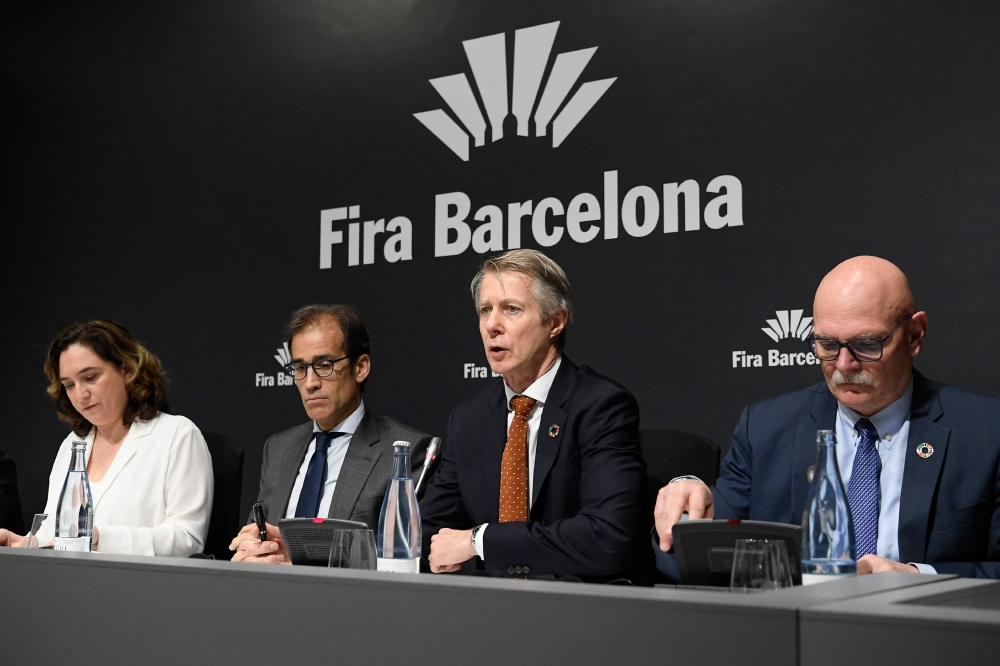 (FromL) Mayor of Barcelona Ada Colau, Chairman of the Board of Administration of Fira de Barcelona Pau Relat, GSMA director general Mats Granryd and GSMA chief executive officer John Hoffman arrive to give a press conference in Barcelona on February 13, 2