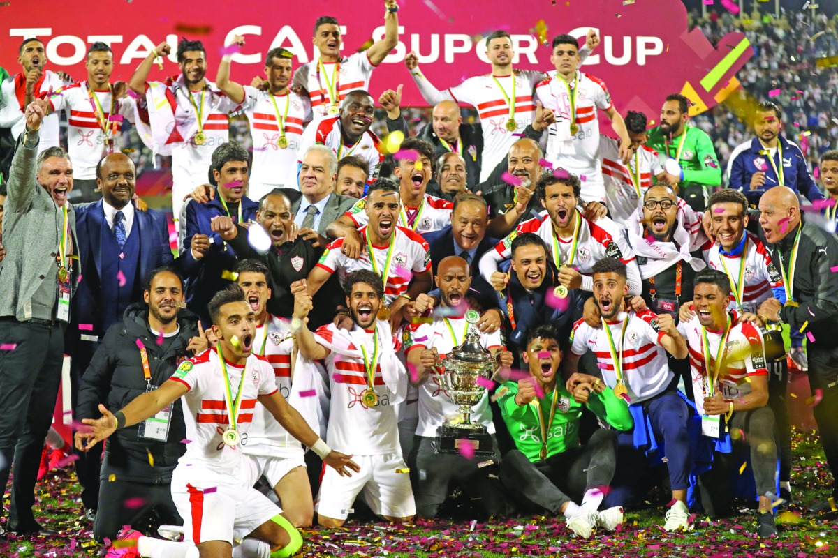 Zamalek's players and officials celebrate with the trophy after winning the CAF Super Cup final against Tunisia’s Esperance at Thani Bin Jassim Stadium in Doha, yesterday.