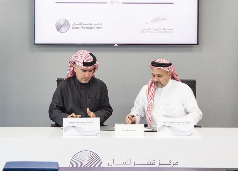 Nasser Ahmed Al Shaibi (left), CEO of the QFMA, and Yousuf Mohamed Al Jaida, CEO and Board Member of the QFCA, signing the MoU.
