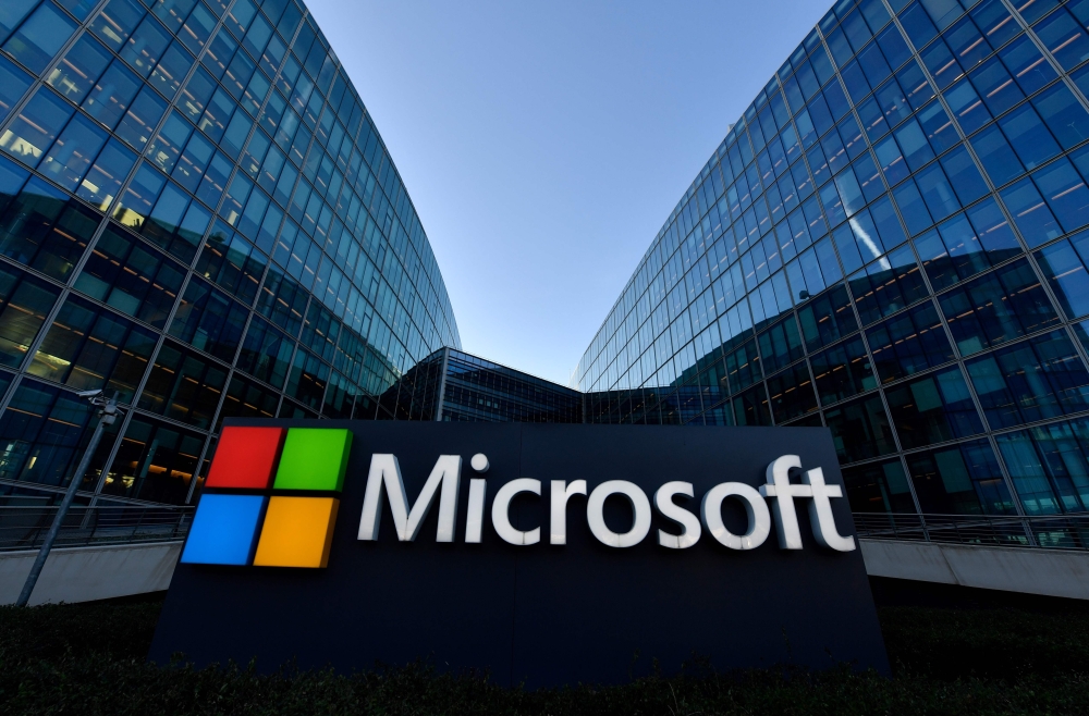 (FILES) In this file photo taken on March 05, 2018 The logo of French headquarters of American multinational technology company Microsoft, is pictured outside on March 6, 2018 in Issy-Les-Moulineaux, a Paris' suburb. AFP / GERARD JULIEN