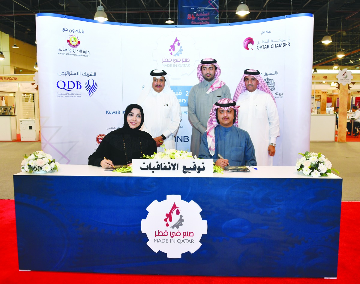 Qatar Chamber Chairman Sheikh Khalifa bin Jassim Al Thani (standing left), witnessing the signing ceremony held on the sidelines of the Made in Qatar’ expo in Kuwait, yesterday. 