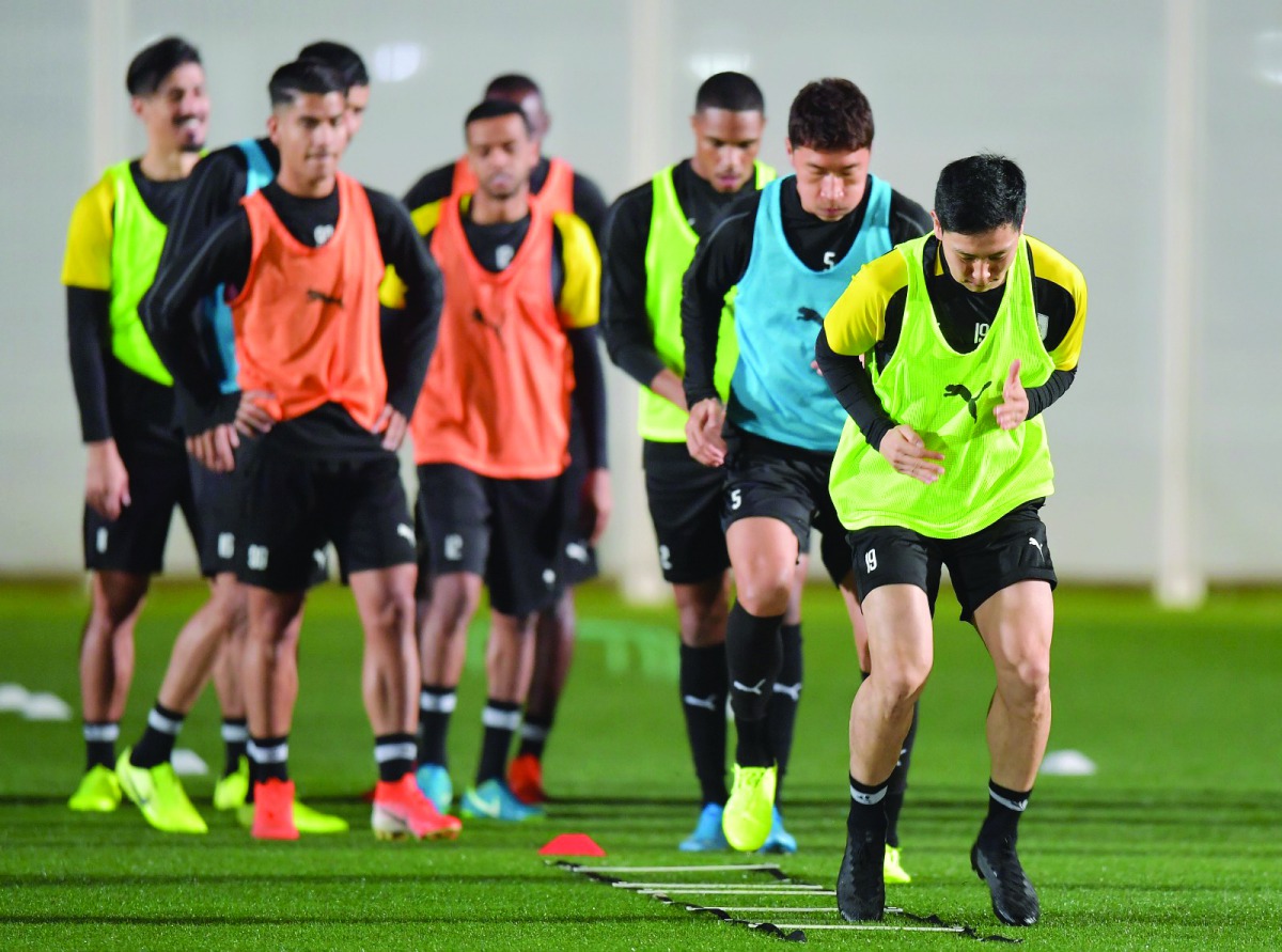 Al Sadd's players in action during a practice session.