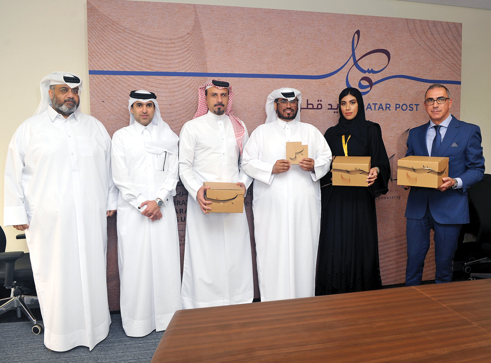 Hamad Mohammed Al Fahida (third right), Chief Operations Officer Qatar Post, with Alberto Manzo, (right) Head of Sales and Marketing; Fatema Al Yousif (second right), Marketing Supervisor Sales and Marketing Department; and other officials at the launch o