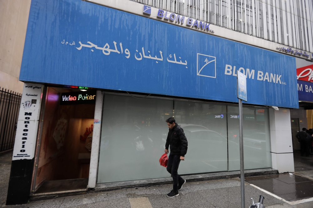 A man walks in front of a bank in the capital Beirut on March 6, 2020. AFP / JOSEPH EID