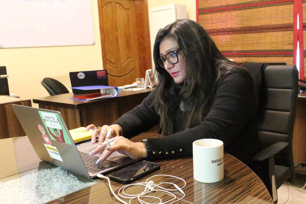 In this picture taken on February 7, 2020, human rights award winner and founder of Pakistan's first cyber-harassment helpline, Nighat Dad, works on her laptop at her office in Lahore. AFP / Amna Yaseen 