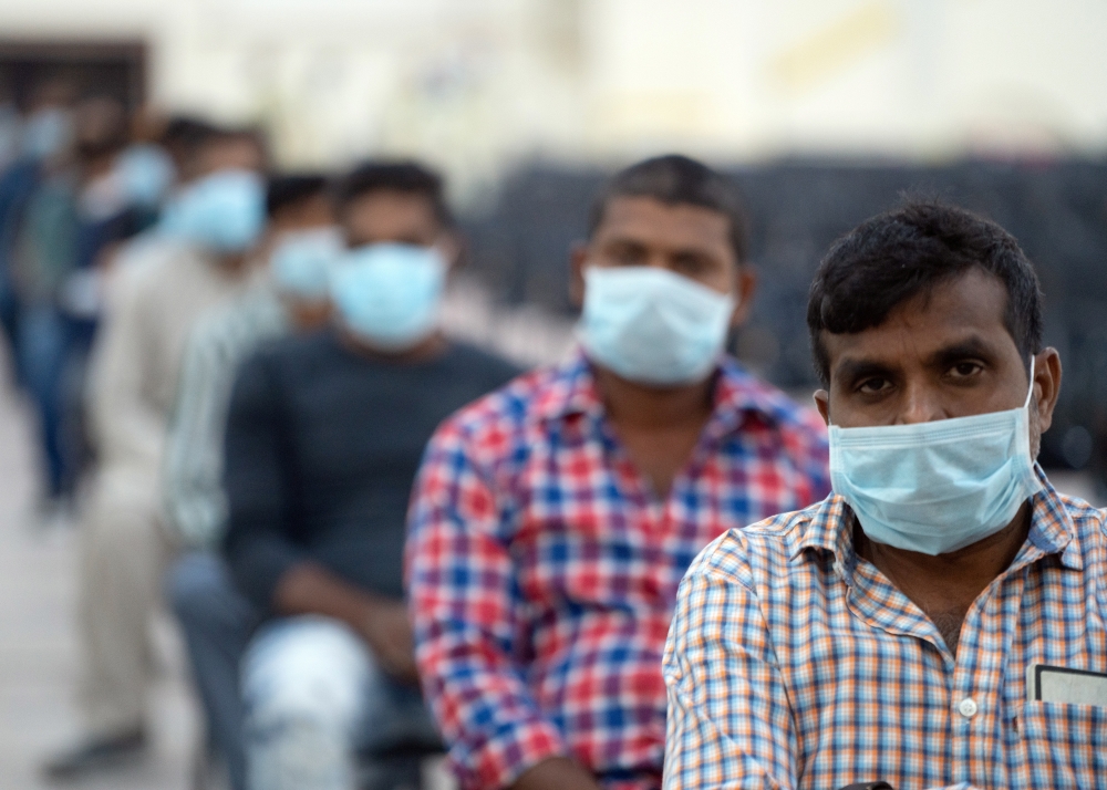 Expatriates wait their turn to be tested at a coronavirus testing centre at Kuwait International Fairgrounds in Mishref, Kuwait March 18, 2020. REUTERS/Stephanie McGehee