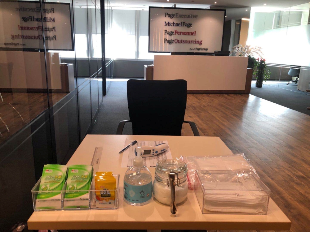 A thermometer, hand sanitizer and masks are pictured in the reception area at PageGroup's office after reopening, as the coronavirus disease (COVID-19) continues, in Shanghai, China, April 29, 2020. Picture taken April 29, 2020. PageGroup/Handout via REUT