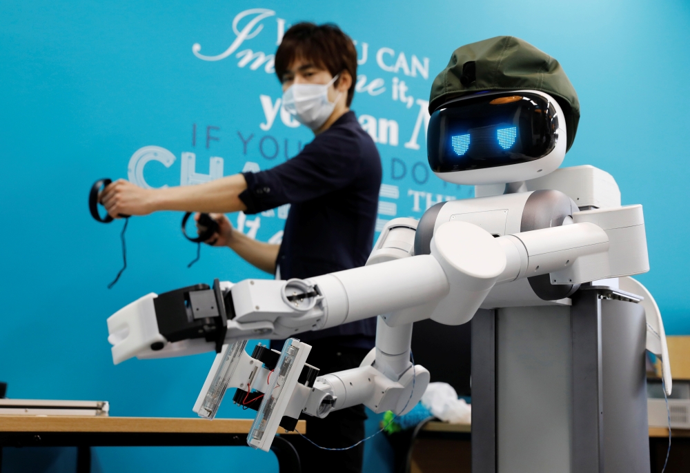Mira Robotics CEO Ken Matsui operates an Ugo avatar robot during a demonstration at the company's laboratory in Kawasaki, Japan June 8, 2020. Picture taken June 8, 2020. REUTERS/Kim Kyung-Hoon