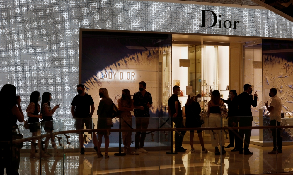 People form a line outside a Dior store in Singapore as the city state reopens the economy amid the coronavirus disease (COVID-19) outbreak, June 19, 2020. Reuters/Edgar Su